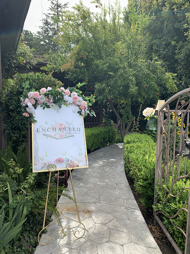 Enchanted Book Club sign and garden path